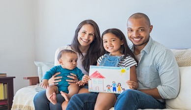 family of four sitting on couch