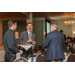 Three men enjoying a conversation at the banquet