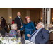 A woman talking with other members at the banquet