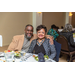 A man and woman smiling sitting at a table