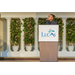 Man standing behind the podium giving a speech