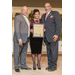 Two men and a woman showing off an award