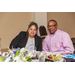 A man and woman sitting at the table in front of salads