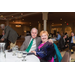 A man and woman pose for photo at the banquet