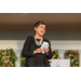 Woman holding cards and giving speech to the audience