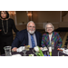 Two guests sitting at a table drinking lemon water