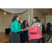 Conversations between 5 women taking place at the entrance of the event