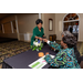 LMHA staff members handing a writing utensil to a guest