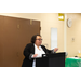 woman in black and white speaking at podium