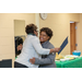 2 women hugging at podium