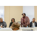 woman standing at table speaking 